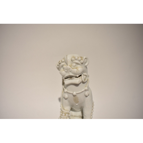 4324 - An 18th Century Chinese blanc-de-chine temple dog on plinth base, 27.5cm tall