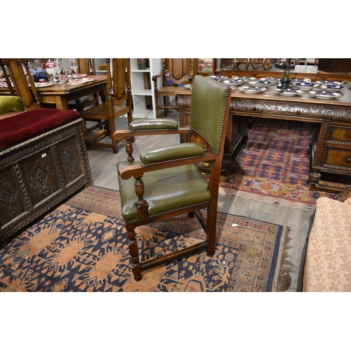 4091 - A 17th Century style oak desk armchair with brass studded leather upholstery