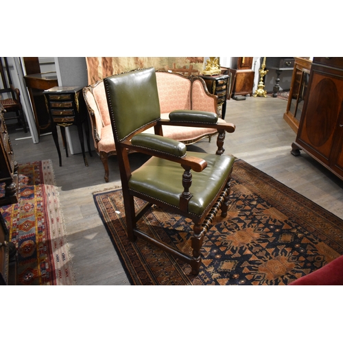 4091 - A 17th Century style oak desk armchair with brass studded leather upholstery