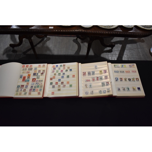 4249 - Four Globe-trotter stamp albums containing unstuck loose used stamps including Elizabeth II, George ... 