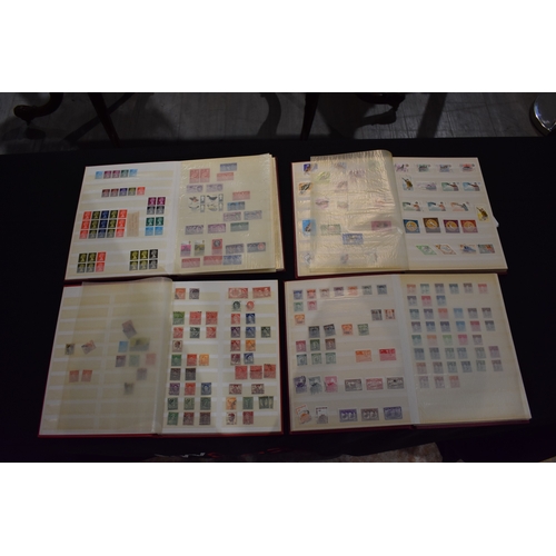 4249 - Four Globe-trotter stamp albums containing unstuck loose used stamps including Elizabeth II, George ... 