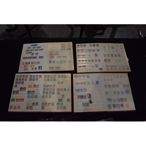 4249 - Four Globe-trotter stamp albums containing unstuck loose used stamps including Elizabeth II, George ... 