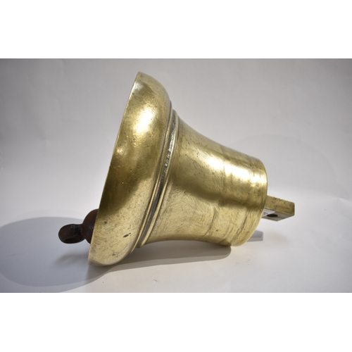 4292 - A George VI polished bronze bell with clanger, approx 28cm tall, 24.5cm diameter base