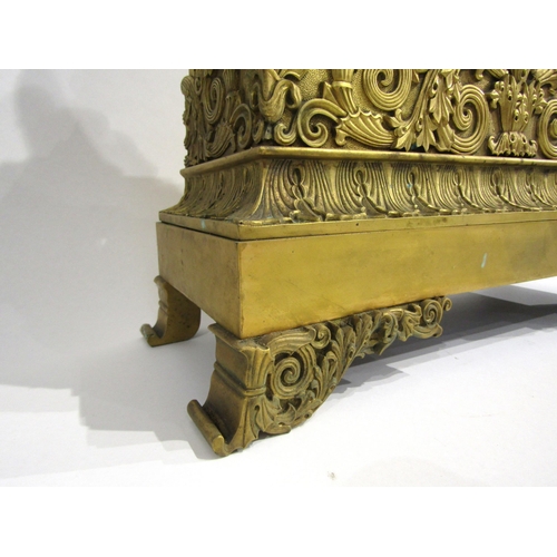 4190 - A large 19th Century gilt metal mantel clock, the ornate scroll design base surmounted by a distingu... 