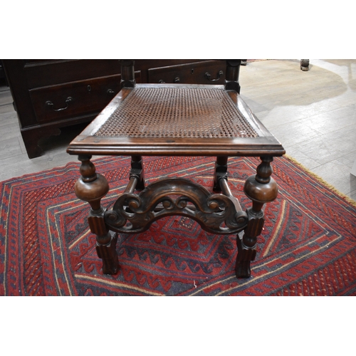 4227 - An English 17th Century carved William and Mary walnut cane back and seat chair, with acanthus scrol... 