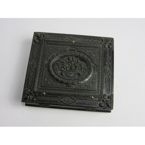 4460 - A Victorian bois durci velvet lined mourning photograph case to include two photographs, one on glas... 