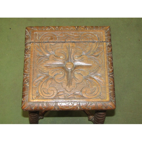 4024 - A Jacobean revival oak stool, 45cm tall with foliate carved seat, 28.5cm x 28.5cm, split in seat