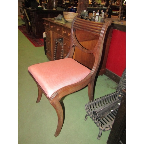 4025 - Possibly Irish, a Regency mahogany chair with reeded curved backrest on sabre fore legs