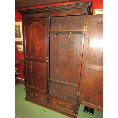 4061 - A circa 1800 and later French panelled oak armoire, the fielded panel two doors with key over two fa... 