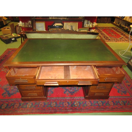 4139 - A circa 1930 vintage panelled mahogany twin pedestal desk with brushing slides over eight drawers on... 