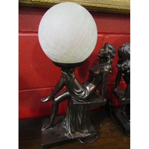 4205 - A pair of Art Deco style figural table lamps, semi-clad maidens with globular shades