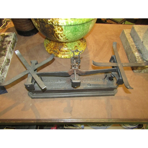 4261 - A pair of cast iron weighing scales with weights and brass pans