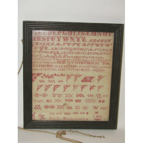 4330 - A late 19th Century needlepoint alphabet sampler by Emily Bridges circa 1863, needle work in red, de... 