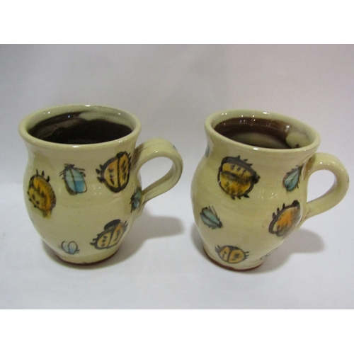 4345 - A studio pottery crocodile plate and a pair of glazed terracotta studio pottery mugs (3)