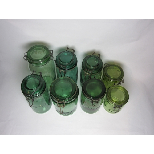 4504 - A collection of eight French 1950's storage / preserving jars in heavy green glass marked with maker... 