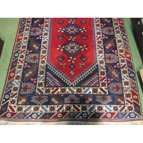 4554 - A Turkish rug, blues and reds, multiple borders, tasselled ends, 230cm x 152cm