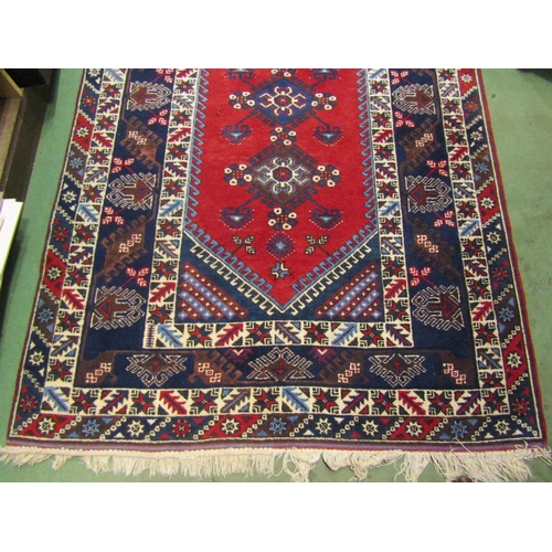 4554 - A Turkish rug, blues and reds, multiple borders, tasselled ends, 230cm x 152cm