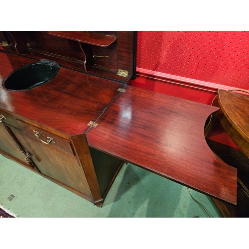 4044 - A French 19th Century mahogany canted corner buffet/sideboard, the rising hinged top with shelf supp... 