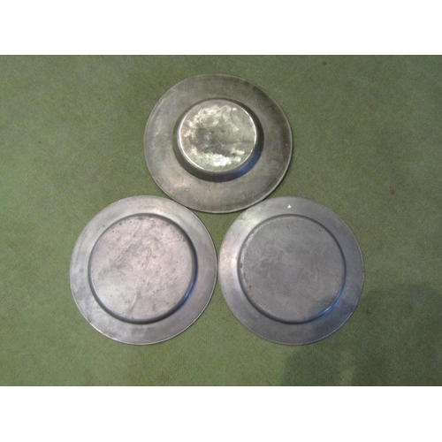 4084 - Three pewter plates, a pair diameter 30cm, one diameter 32cm marked with a crowned coat of arms