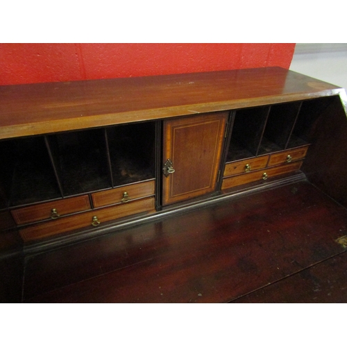 4207 - An Edwardian crossbanded mahogany bureau, the fitted interior over four graduating drawers on bracke... 