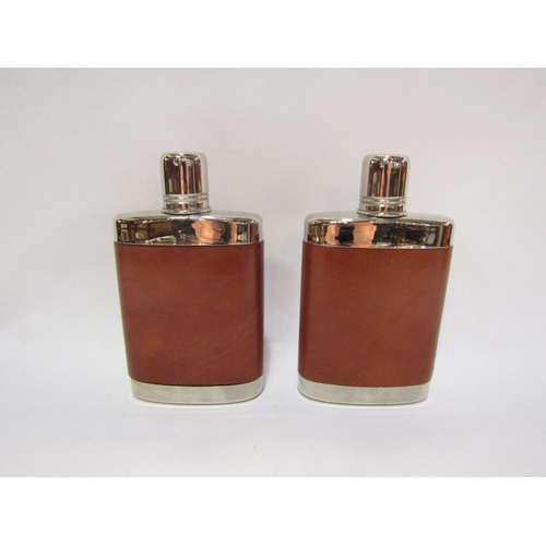 4361 - A pair of leather bound hip flasks, 11cm x 8cm x 2cm in a zipped leather carrying case