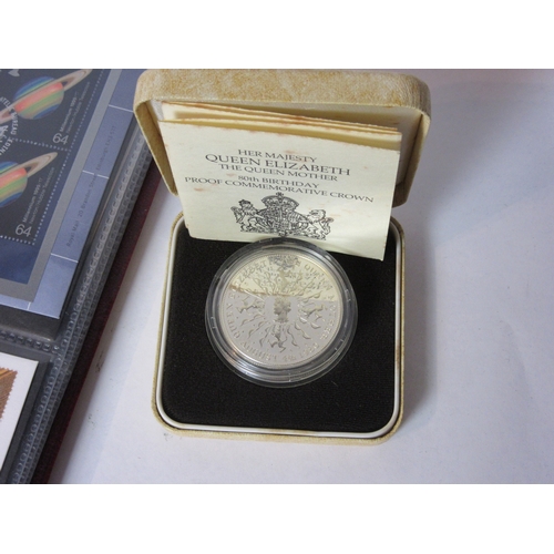 4537 - A collectors book of stamps and coins and a Sterling silver commemorative crown for Queen Mother's 8... 