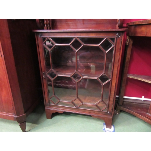 4049 - A George III mahogany cabinet of small proportions, the swan-neck pediment over a raised shelf on tu... 