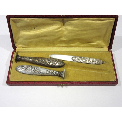 1332 - A cased Art Nouveau letter opener and wax seal/stamp (blank) with floral design, together with anoth... 