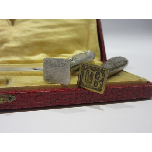 1332 - A cased Art Nouveau letter opener and wax seal/stamp (blank) with floral design, together with anoth... 