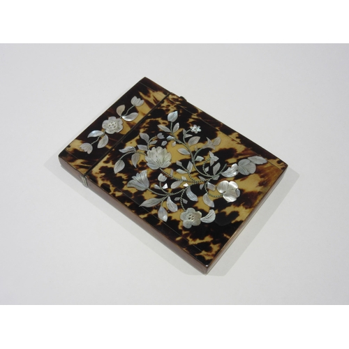 1334 - A Victorian tortoiseshell card case with inlaid mother-of-pearl floral decoration