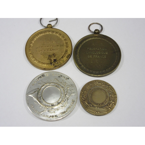 1349 - A collection of four French dog show medals, including one in silvered bronze by artist Lucien Caria... 