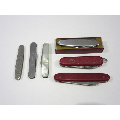 1350 - A collection of six vintage penknives, featuring one Swiss army knife and one with a mother-of-pearl... 