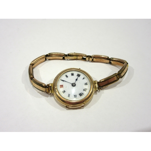 1380 - A lady's 9ct cased wristwatch with enamelled Roman numeral dial, total weight 19g