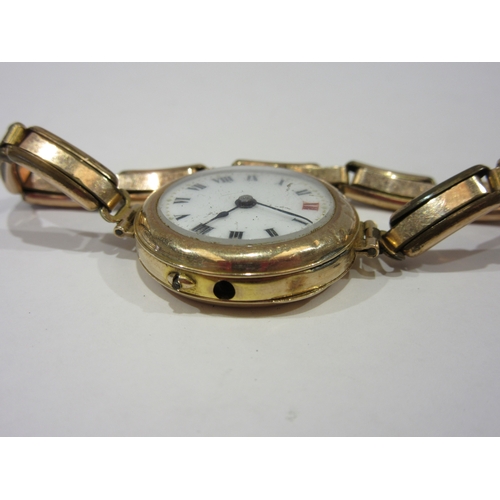 1380 - A lady's 9ct cased wristwatch with enamelled Roman numeral dial, total weight 19g