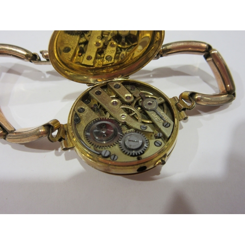 1380 - A lady's 9ct cased wristwatch with enamelled Roman numeral dial, total weight 19g