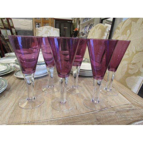 1132A - A set of six drinking glasses with conical amethyst coloured bowls and clear stems