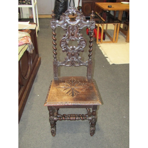 1140 - A pair of ornate carved oak chairs, spiral twist form supports and carved back nests