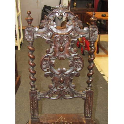 1140 - A pair of ornate carved oak chairs, spiral twist form supports and carved back nests