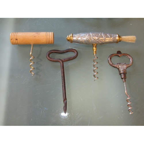 1198 - A collection of four vintage French corkscrews, including one with a brush