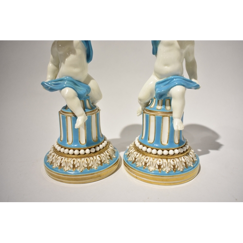 4040 - A pair of 19th Century Minton candlesticks, boys wrapped in cloth turquoise and gilt some rubbing pr... 