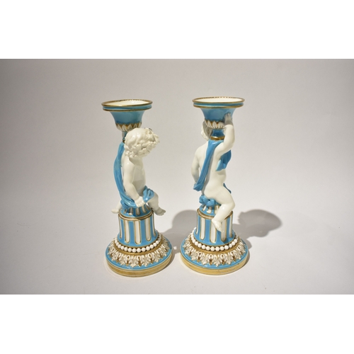 4040 - A pair of 19th Century Minton candlesticks, boys wrapped in cloth turquoise and gilt some rubbing pr... 