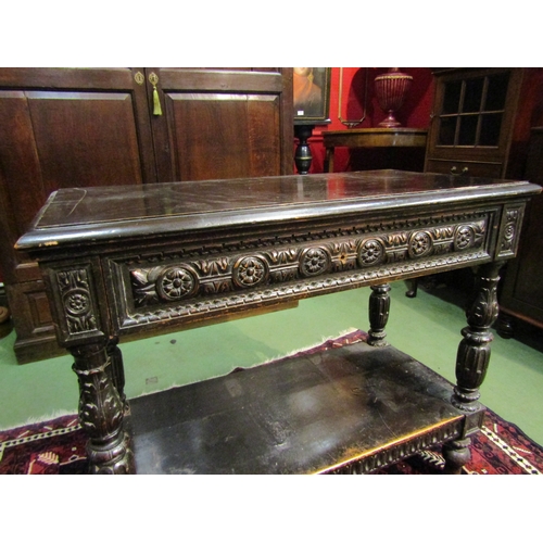 4071 - A 19th Century Jacobean style two-tier single drawer serving table, intricately carved frieze and su... 