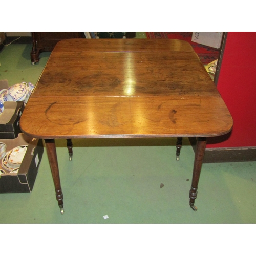 4001 - A 19th Century mahogany Pembroke table, single drawer and faux drawer, ring turned legs to brass cas... 