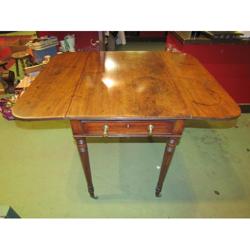 4001 - A 19th Century mahogany Pembroke table, single drawer and faux drawer, ring turned legs to brass cas... 