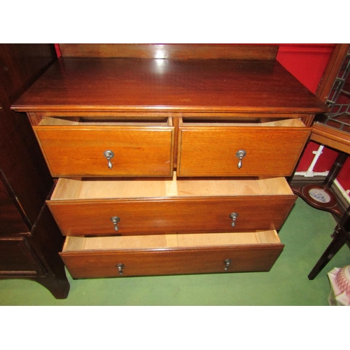 4042 - A circa 1930 oak chest of two short over two long drawers on square tapering foot legs with carved d... 