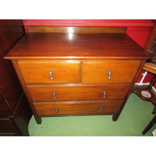 4042 - A circa 1930 oak chest of two short over two long drawers on square tapering foot legs with carved d... 