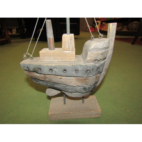 4044 - A hardwood model of a boat with mast, 34cm tall