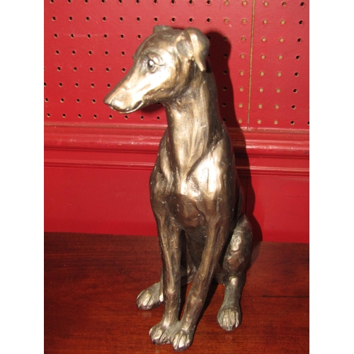 4049 - A bronzed figure of a seated greyhound, 31cm tall