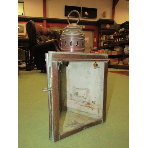 4055 - A copper wall hanging candle lantern with two glass inserts, 36cm tall