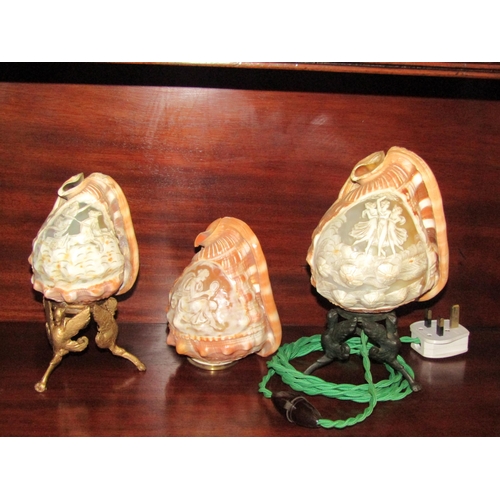 4063 - An ornately carved cameo conch shell table lamp and two shades